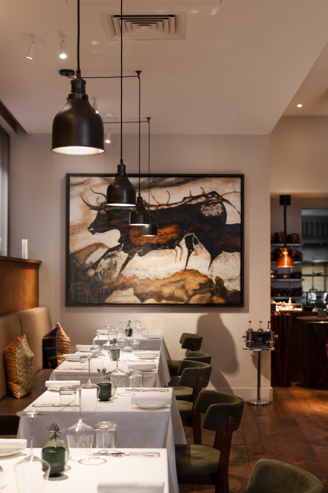 Origin City restaurant dining room artwork and banquette setting