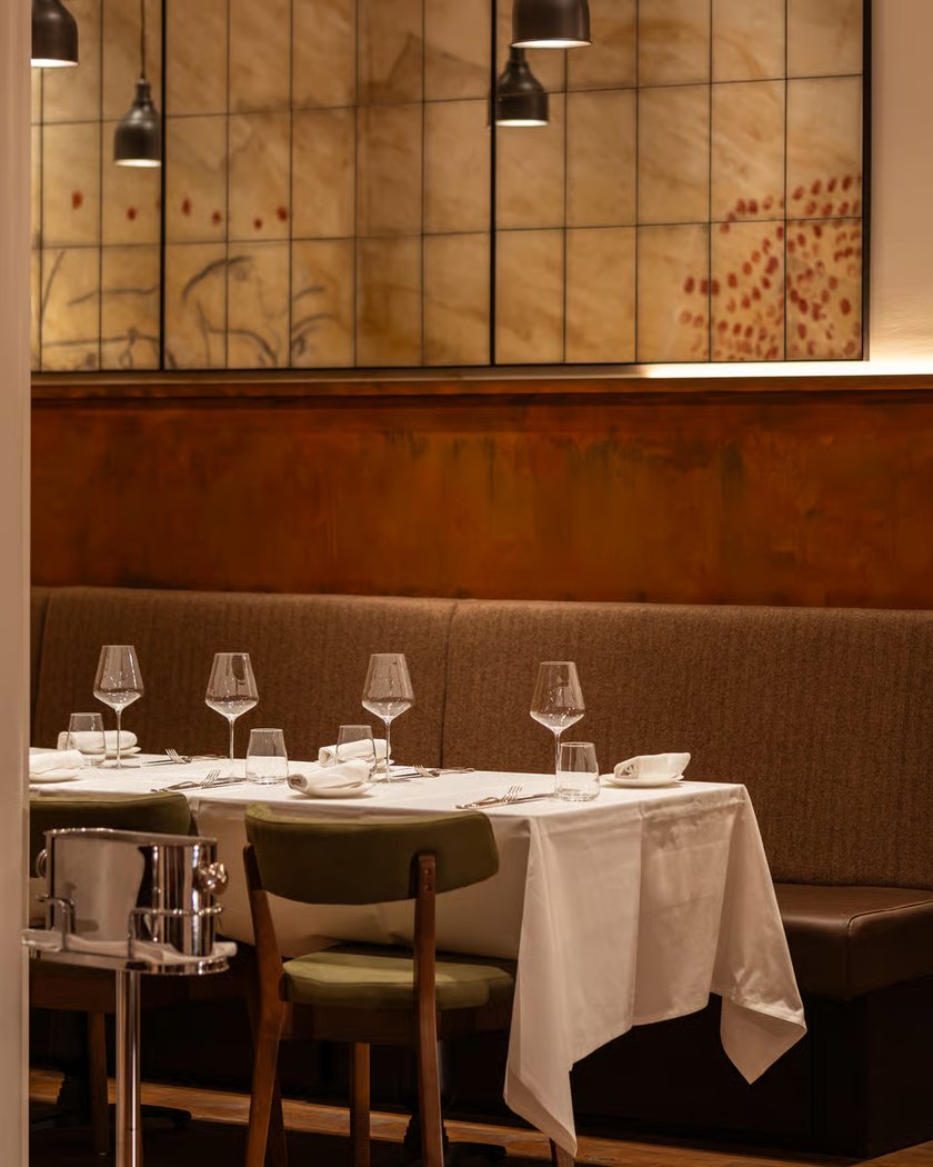 Origin City restaurant dining room with warm lighting and wall art