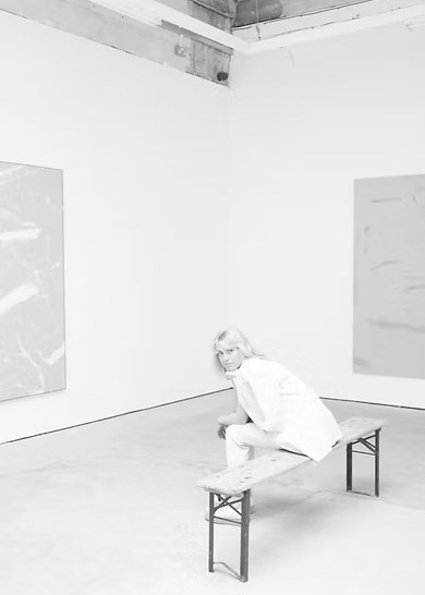 Emma Richeldis seated in a bright gallery interior
